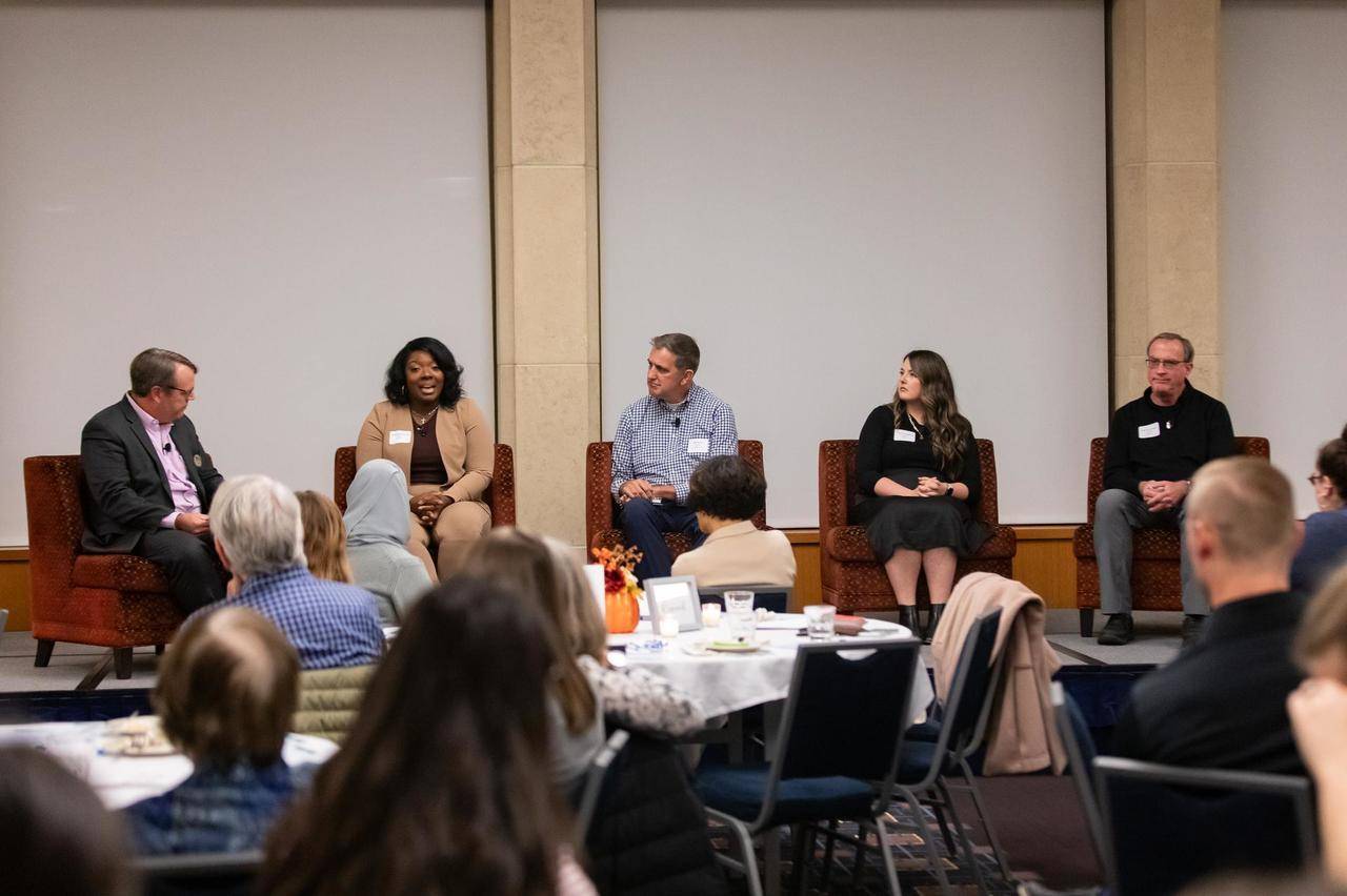 Guest speaker panel at the symposium on stage